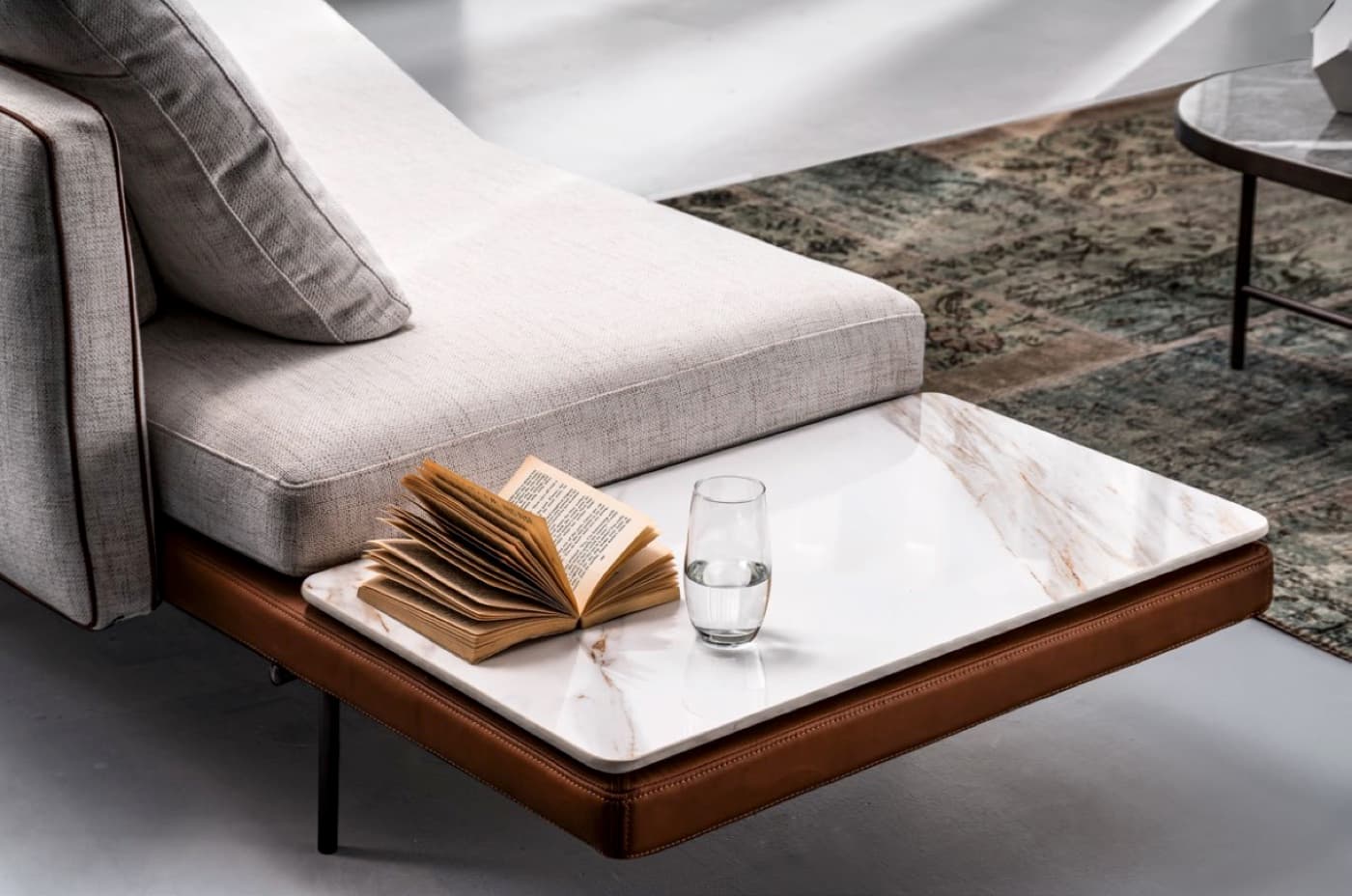 Close-up furniture scene with sofa, marble table and interior styling